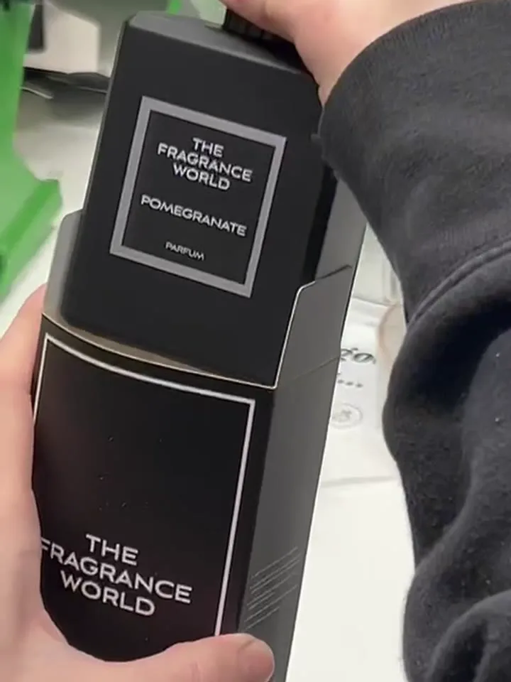 A black Pomegranate box going into its sleeve